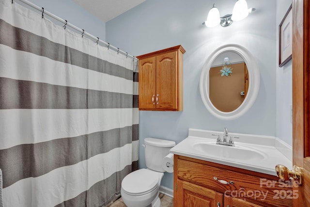 bathroom featuring vanity and toilet