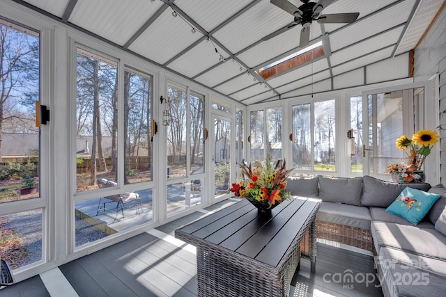 sunroom / solarium with ceiling fan and vaulted ceiling