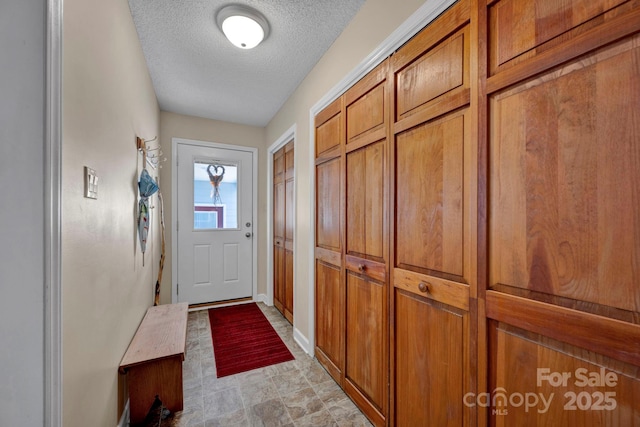 doorway with a textured ceiling