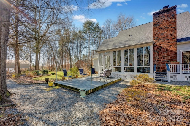 view of yard with a deck and a sunroom