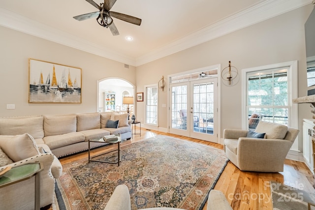 living room featuring crown molding, ceiling fan, french doors, and wood-type flooring