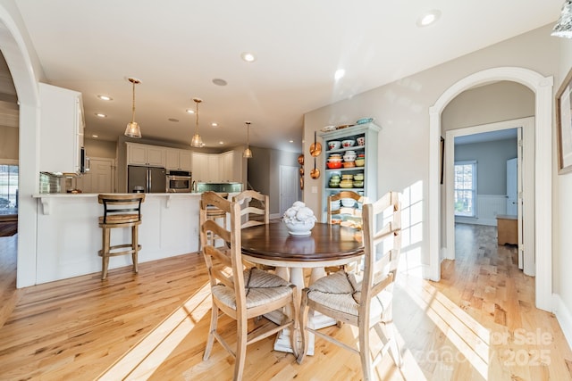 dining space featuring light wood-type flooring