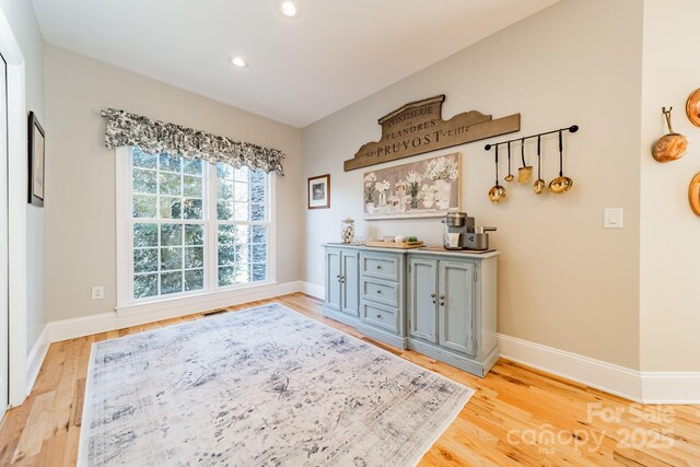 interior space featuring gray cabinetry and light hardwood / wood-style flooring