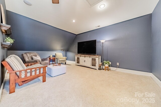 carpeted living room featuring vaulted ceiling