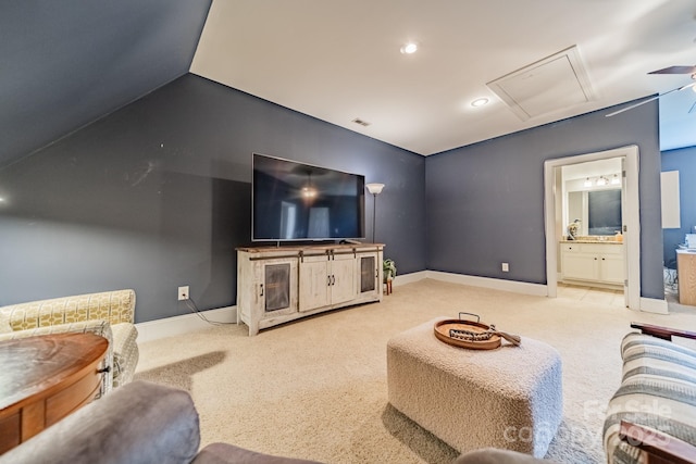 carpeted living room featuring ceiling fan and vaulted ceiling