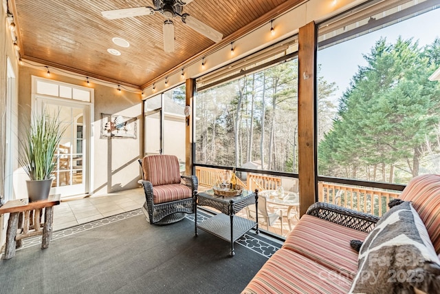 sunroom / solarium featuring ceiling fan and wooden ceiling