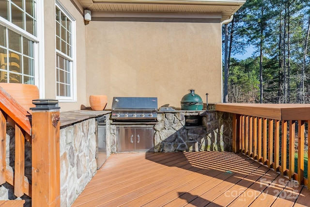 wooden deck featuring area for grilling and a grill