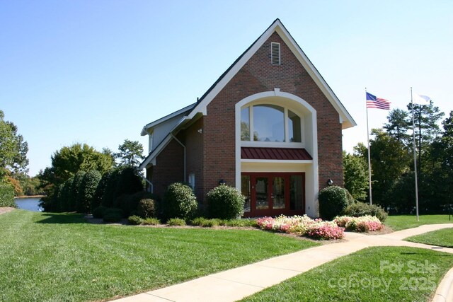 view of front facade featuring french doors and a front lawn