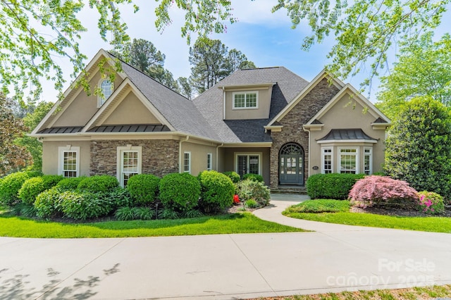 4150 Summit Ridge Ln, Denver, NC 28037 - view of front facade with stone siding, a standing seam roof, stucco siding, and roof with shingles
