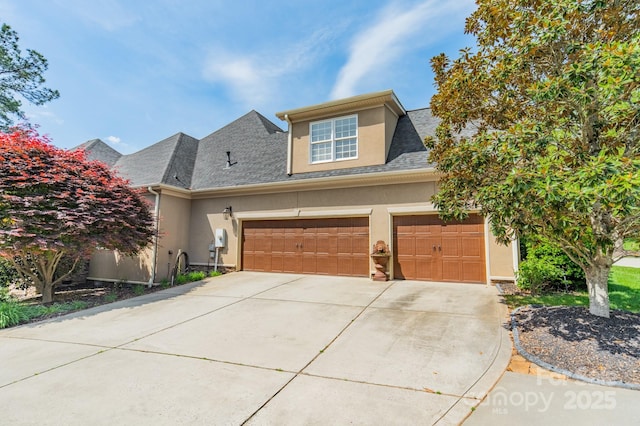 4150 Summit Ridge Ln, Denver, NC 28037 - view of front of house featuring stucco siding, driveway, an attached garage, and a shingled roof