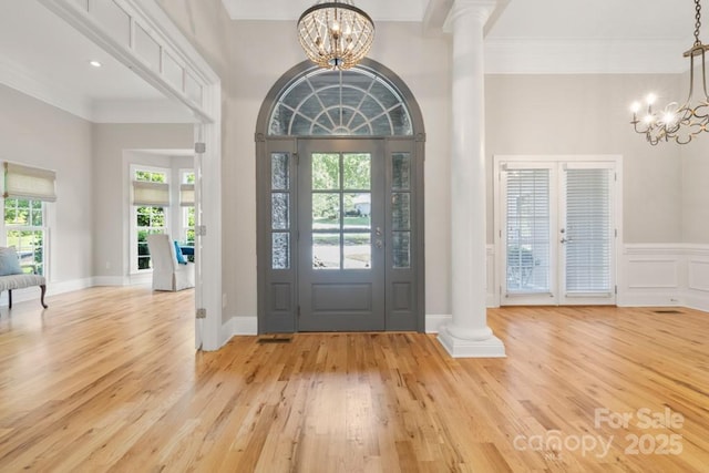 4150 Summit Ridge Ln, Denver, NC 28037 - foyer entrance featuring a chandelier, ornate columns, light wood-style floors, and ornamental molding