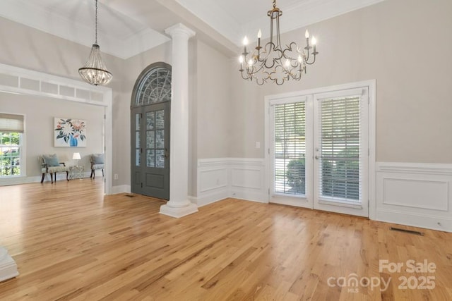 4150 Summit Ridge Ln, Denver, NC 28037 - unfurnished dining area featuring a chandelier, wood finished floors, ornamental molding, a decorative wall, and a wainscoted wall