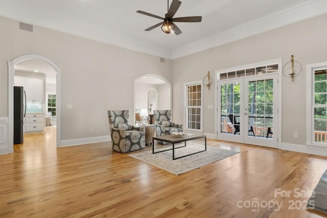 4150 Summit Ridge Ln, Denver, NC 28037 - living area with arched walkways, light wood-type flooring, ceiling fan, crown molding, and french doors