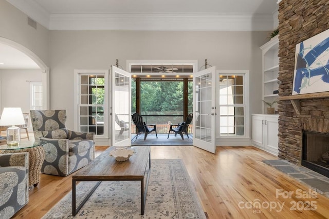 4150 Summit Ridge Ln, Denver, NC 28037 - living room with ornamental molding, wood finished floors, french doors, arched walkways, and healthy amount of natural light