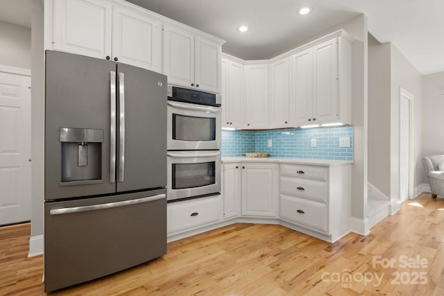 4150 Summit Ridge Ln, Denver, NC 28037 - kitchen with stainless steel appliances, light countertops, white cabinetry, light wood-style floors, and recessed lighting