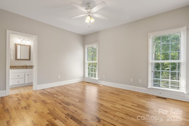 4150 Summit Ridge Ln, Denver, NC 28037 - unfurnished bedroom with light wood-type flooring, multiple windows, baseboards, and ensuite bath