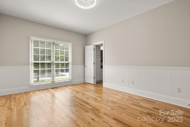 4150 Summit Ridge Ln, Denver, NC 28037 - unfurnished room featuring a wainscoted wall, wood finished floors, and baseboards