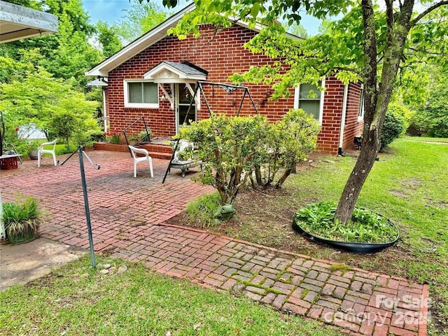 exterior space with a lawn and a patio area