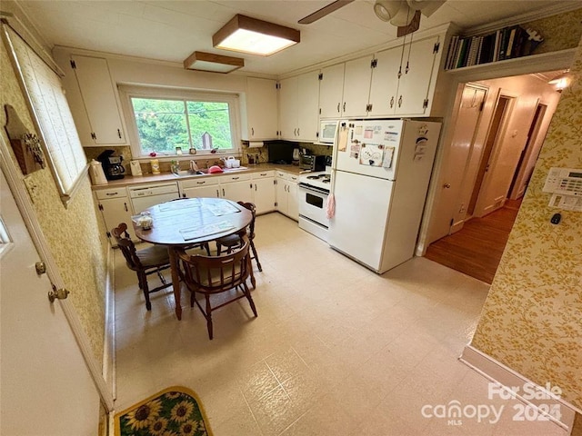 kitchen with white cabinetry, sink, ceiling fan, and white appliances