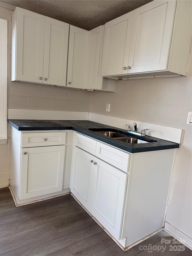 kitchen featuring sink, white cabinets, and dark hardwood / wood-style floors