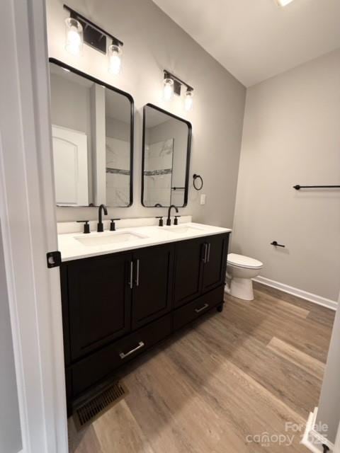 bathroom featuring vanity, toilet, and wood-type flooring