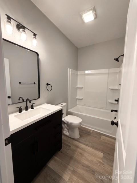 full bathroom featuring vanity, hardwood / wood-style flooring, toilet, and tub / shower combination