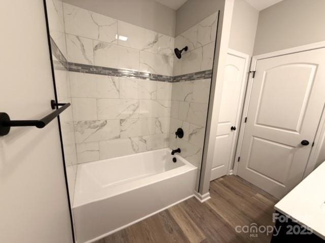 bathroom featuring vanity, tiled shower / bath combo, and hardwood / wood-style flooring