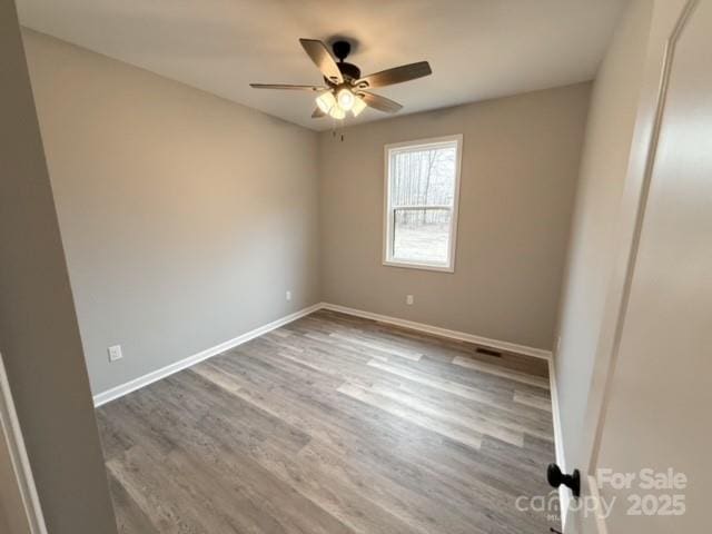 unfurnished room with hardwood / wood-style floors and ceiling fan