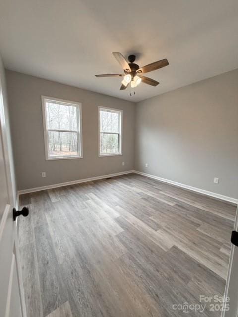 spare room featuring ceiling fan and light hardwood / wood-style flooring