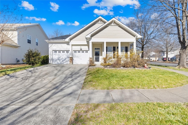 view of front of property with a garage, a front yard, and covered porch