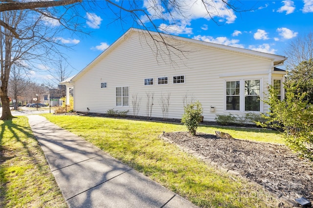 view of home's exterior with a lawn