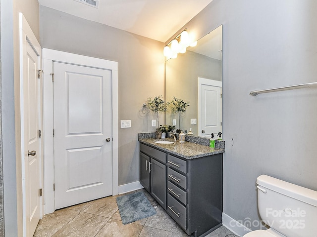 bathroom featuring tile patterned floors, vanity, and toilet