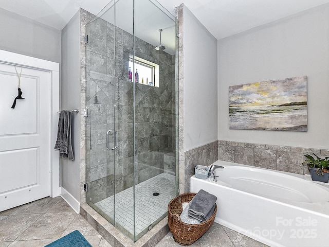 bathroom featuring tile patterned floors and shower with separate bathtub