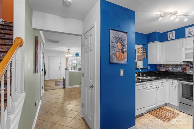 kitchen with white cabinets, white appliances, sink, and tasteful backsplash