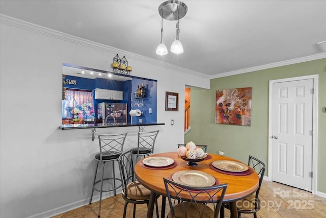 dining area with bar area and ornamental molding