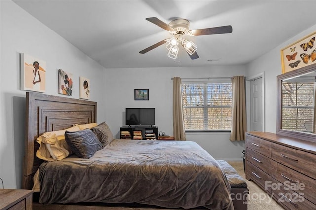 carpeted bedroom with ceiling fan