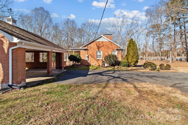 view of side of home featuring a carport