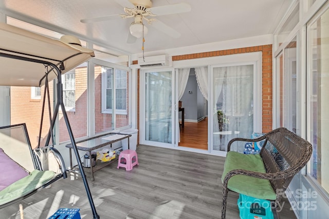 sunroom / solarium featuring a wall mounted AC and ceiling fan