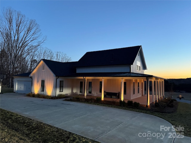 view of front of home with a porch and a garage