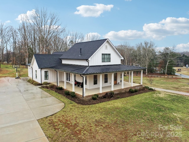 view of side of property with a porch and a yard