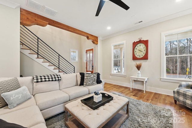 living room with ceiling fan, beam ceiling, crown molding, and hardwood / wood-style floors