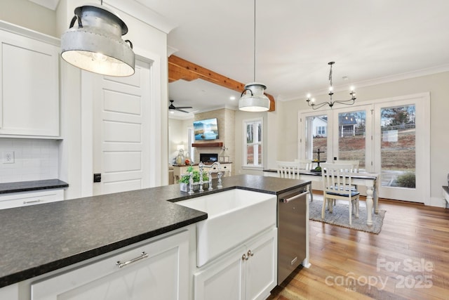 kitchen with decorative light fixtures, decorative backsplash, and white cabinetry