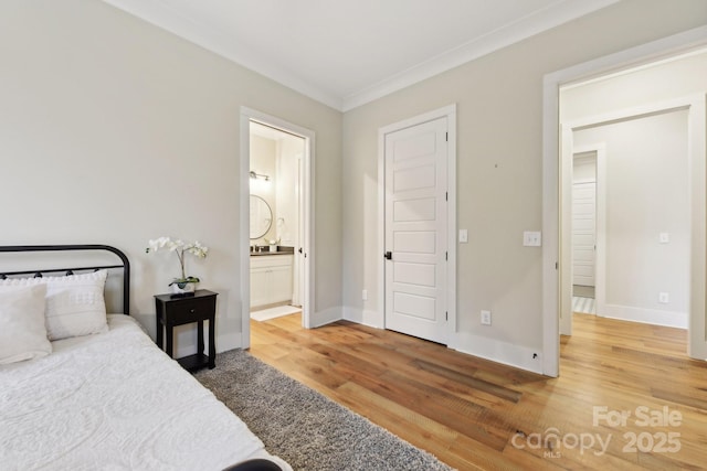 bedroom featuring hardwood / wood-style flooring, connected bathroom, and ornamental molding