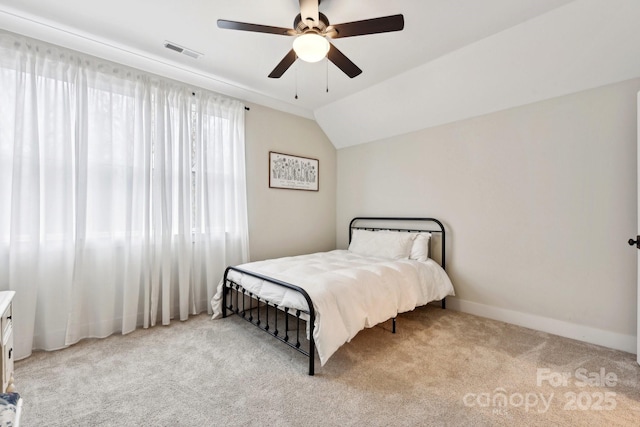 carpeted bedroom with ceiling fan, lofted ceiling, and multiple windows