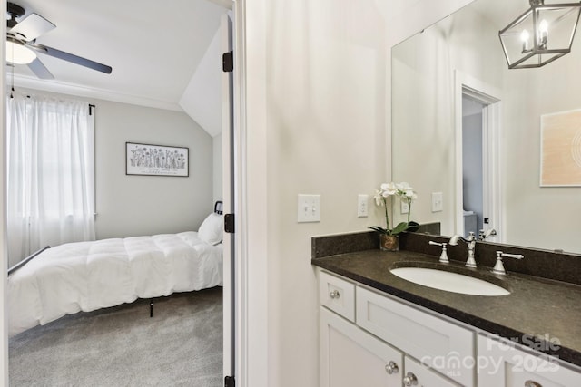 bathroom featuring ceiling fan, vanity, and vaulted ceiling