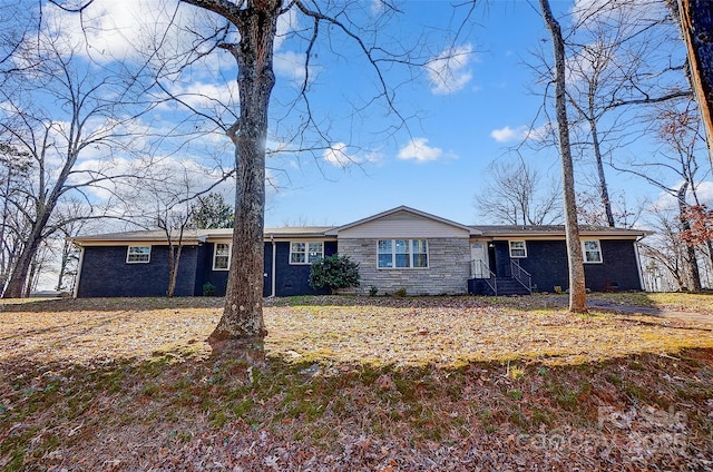 ranch-style home with a front lawn