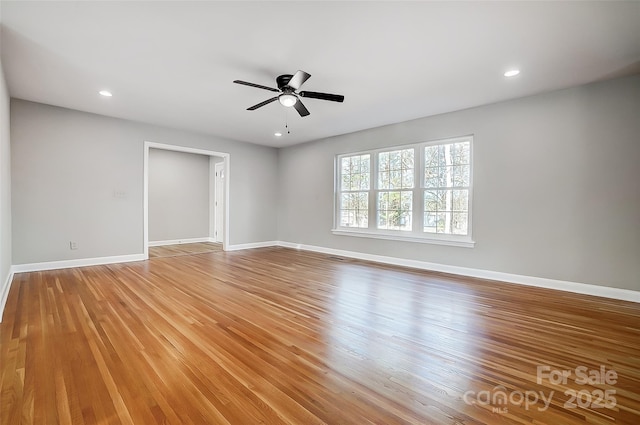 empty room with light wood-type flooring and ceiling fan