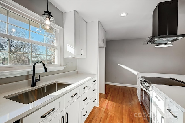 kitchen with sink, electric stove, white cabinets, exhaust hood, and light wood-type flooring