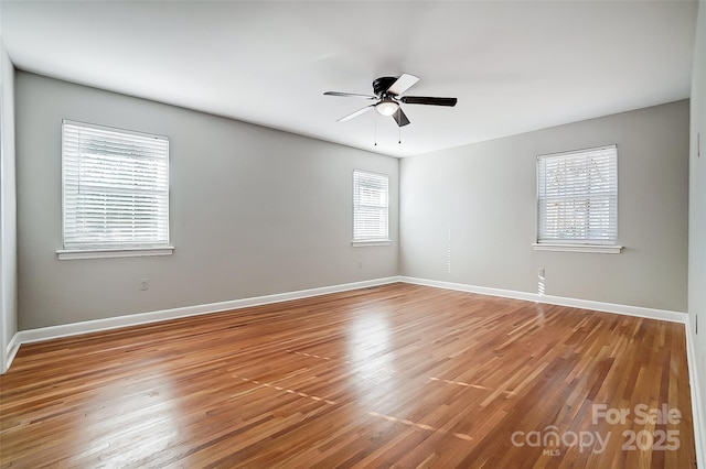 empty room featuring hardwood / wood-style floors and ceiling fan