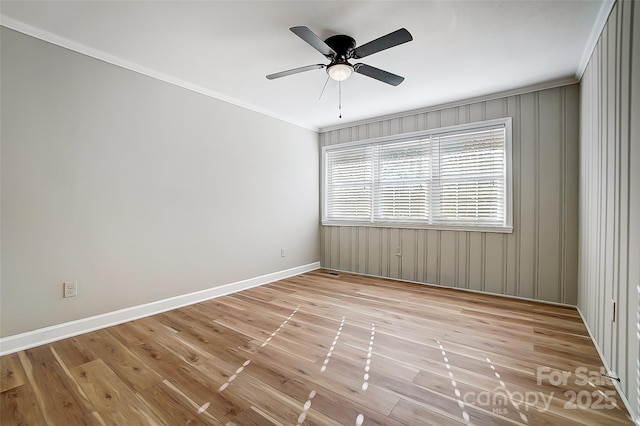 spare room featuring ceiling fan, crown molding, and light hardwood / wood-style flooring